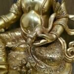 24K gold plated Dzambhala (Jambhala) statue, 22cm tall, handcrafted Buddhist wealth deity with intricate detailing, blue facial highlights, and ornate lotus pedestal base.