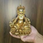 24K gold-plated Dzambhala (Jambhala/Zambala) statue, 17 cm tall, 13 cm base, 1.10 kg — handcrafted Buddhist wealth deity with blue facial highlights on an ornate lotus pedestal.