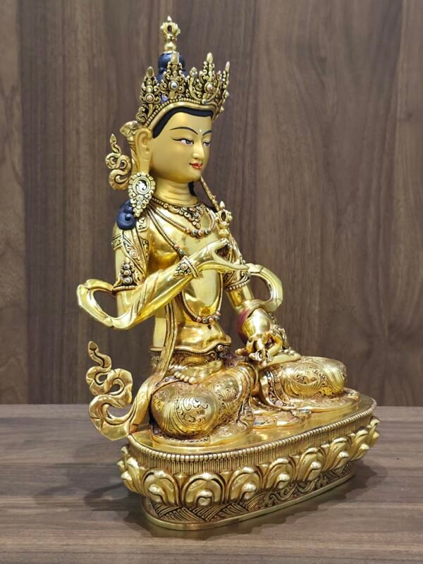 Left three-quarter view of Vajrasattva statue, 24K gold-plated copper and gold-powder face, bell at hip, fine hand-chased details.