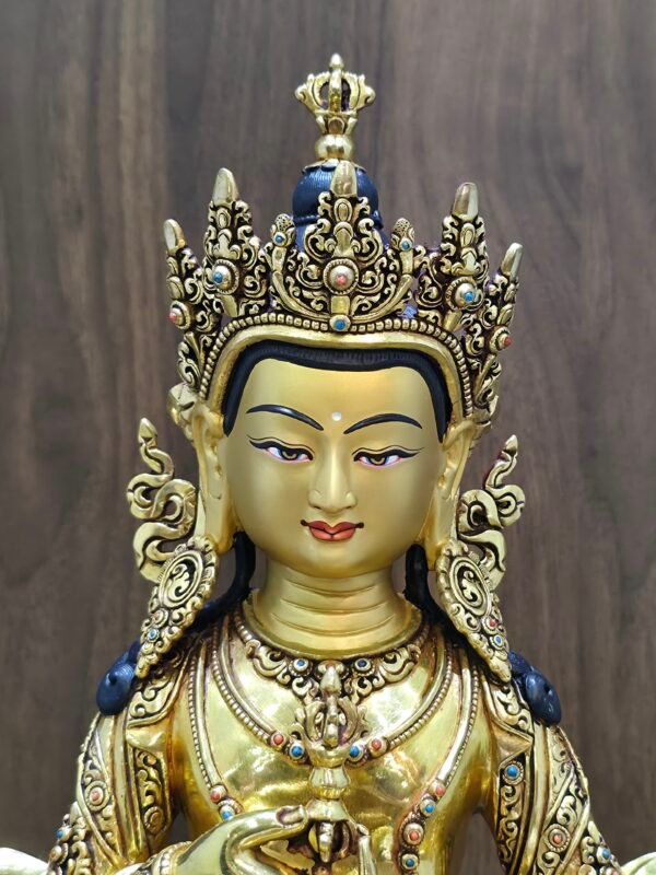 Close-up of Vajrasattva statue’s gold-powder painted face and five-leaf crown with gemstone inlay, 24K gold-plated copper.