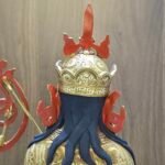 Detail shot of the back of Guru Rinpoche's lotus hat and crown, highlighting the 24K gold plating and hand-painted details.