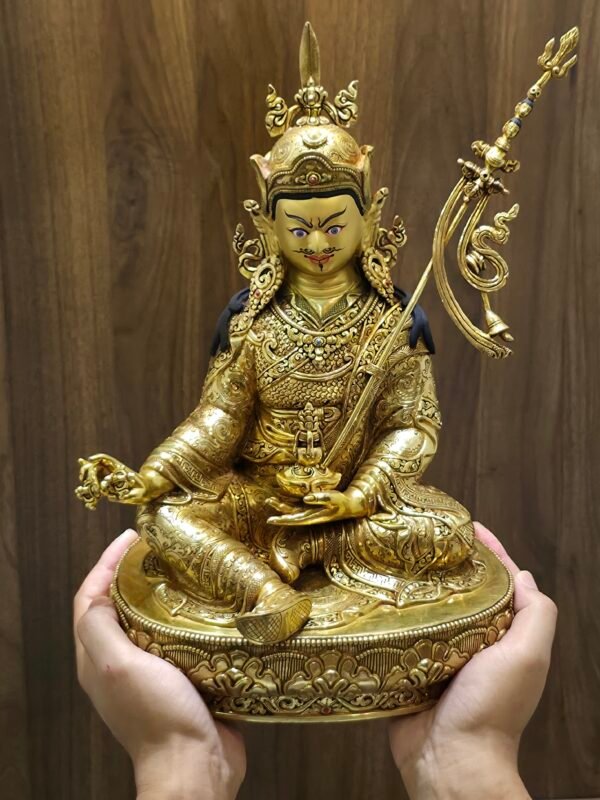 A hand holding the bottom of the statue to demonstrate the scale and the raw copper finish of the base plate.