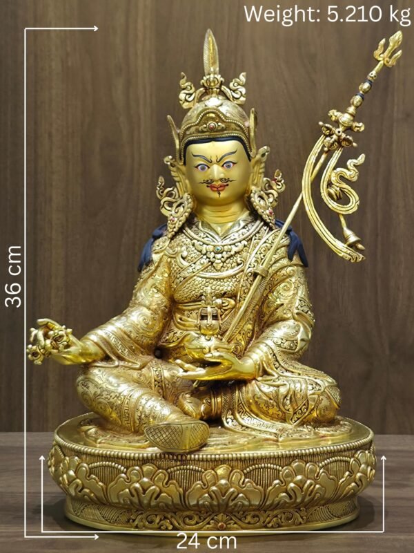 Full front view of 24K gold plated Guru Rinpoche statue seated on a lotus base with khatvanga staff showing the measurements and weight.