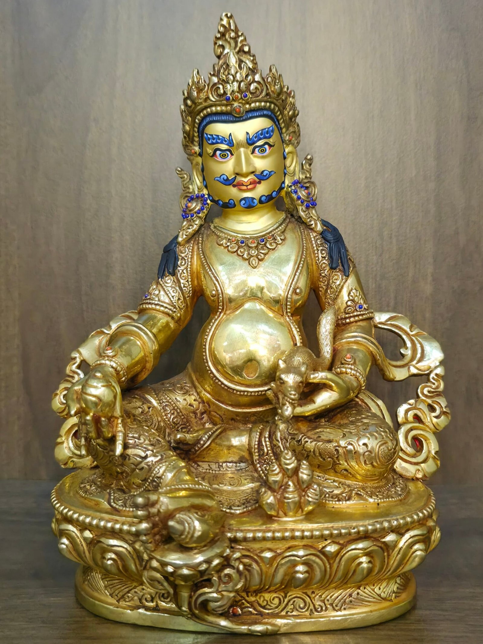 Yellow Dzambhala (Jambhala) wealth-deity statue — 24K gold-plated copper with gold-powder painted face, holding mongoose and citron/wealth fruit on detailed lotus pedestal.