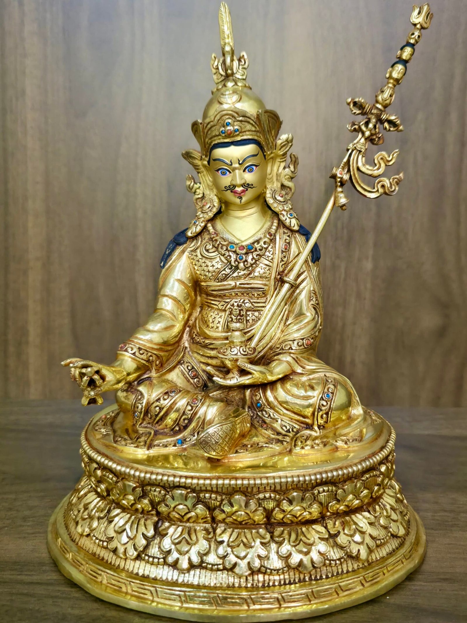Full front view of 24K gold plated Guru Rinpoche Padmasambhava statue seated on a lotus base.