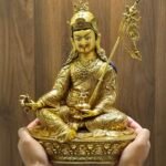 Person holding large 36cm Guru Rinpoche statue to demonstrate size and scale for home display.