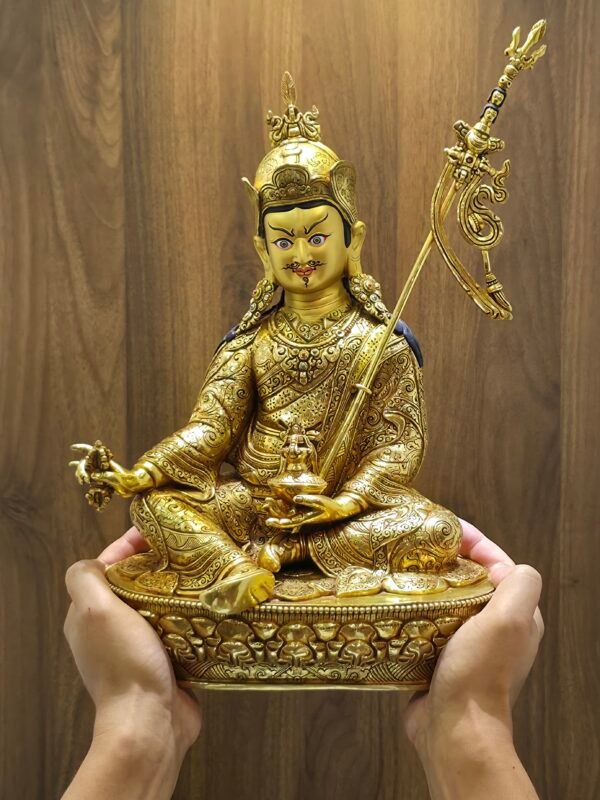 Person holding large 36cm Guru Rinpoche statue to demonstrate size and scale for home display.