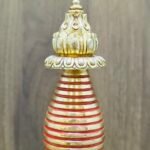 Close-up of spire rings and finial on Kadampa stupa chorten, red accents