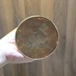 Underside base view of copper stupa chorten with stamped detail, gold plated rim.