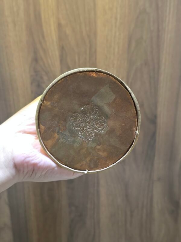 Underside base view of copper stupa chorten with stamped detail, gold plated rim.