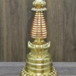Tibetan-style Buddhist stupa (chorten) in 24K gold-plated copper, red accent rings on spire, front view.