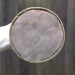 Underside of stupa base showing copper bottom and engraved vajra motif, Tibetan Buddhist chorten.