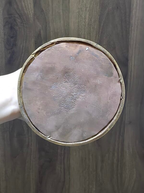 Underside of stupa base showing copper bottom and engraved vajra motif, Tibetan Buddhist chorten.