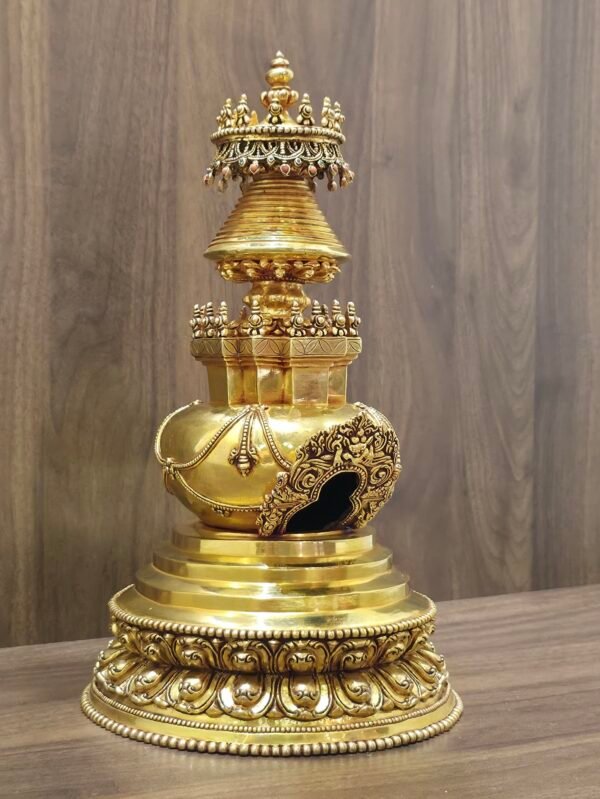 Angled right view of gold plated copper stupa showing carved arch window, stepped base, and detailed canopy with inlays.