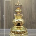 Gold plated copper Buddhist stupa with on image measurements showing 32 cm height and 18 cm base width.