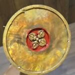 Bottom view showing raised vajra emblem on the underside of the gold plated copper stupa.