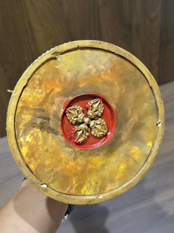 Bottom view showing raised vajra emblem on the underside of the gold plated copper stupa.