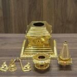 Stupa shown disassembled with separate sections laid out, revealing hollow openings for filling and assembly parts.