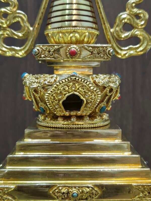 Three quarter view highlighting stepped base corners, lotus rim, and decorative panels with red and turquoise colored inlays.