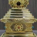 Straight on view showing the central decorative panel on the base and the upper section with arched niche detail.