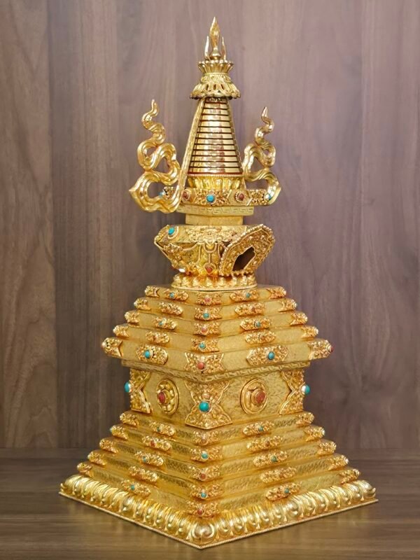 Three quarter view of the full stupa showing the tiered square base, engraved panels, inlay accents, and balanced altar ready silhouette.