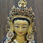 Close-up of Princess Mandarava's face, meticulously painted with pure gold powder, featuring a turquoise-inlaid crown.