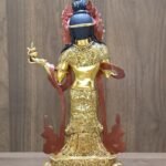 Detailed close-up of the back of the Mandarava statue, focusing on the fine floral patterns engraved into her robes.