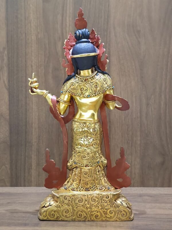 Detailed close-up of the back of the Mandarava statue, focusing on the fine floral patterns engraved into her robes.