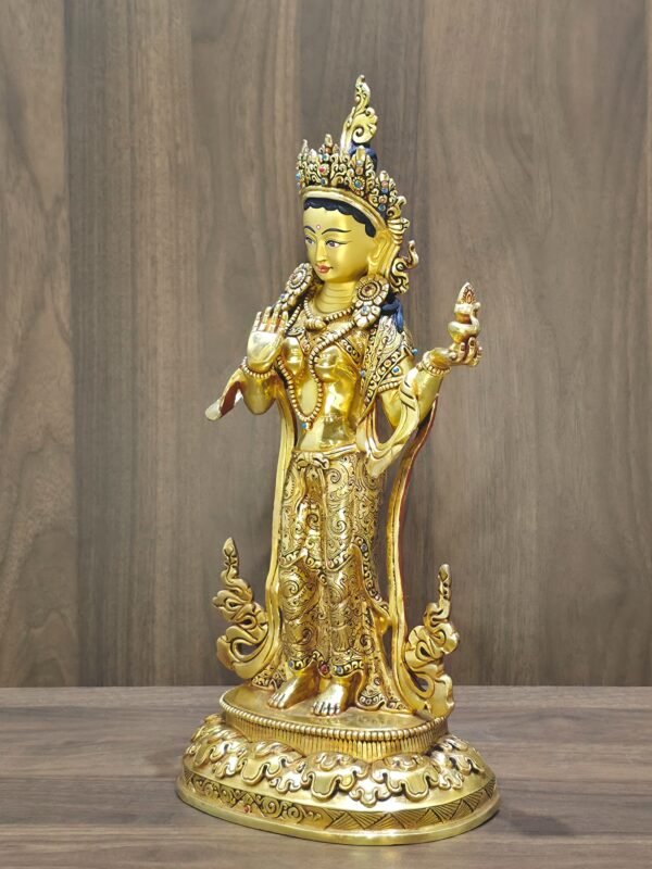 Right side angle of 24K gold plated Mandarava statue.