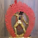 Back view of 24K gold plated Vajrayogini statue showing the open consecration chamber and the detachable wisdom fire aura painted red on the reverse.