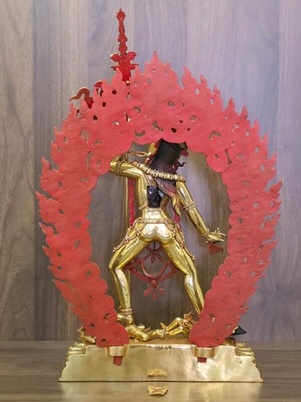 Back view of 24K gold plated Vajrayogini statue showing the open consecration chamber and the detachable wisdom fire aura painted red on the reverse.