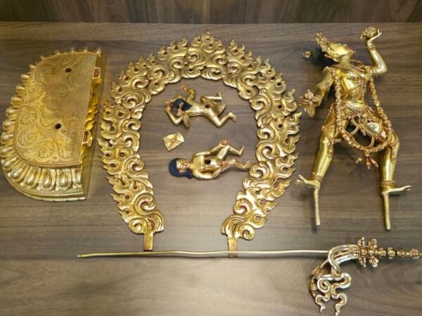 Flat lay showing the fully disassembled parts of the master quality Vajrayogini statue, including the lotus base, flaming aura, main body, khatvanga staff, and prostrate figures.