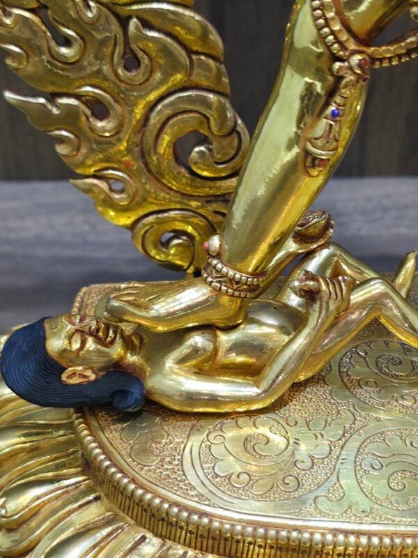 Artisanal detail of the lotus base and the worldly deities beneath the feet of the gold plated Vajrayogini.
