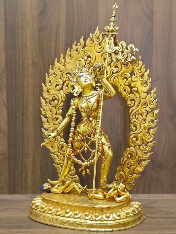 Side view of the Vajrayogini sculpture highlighting the intricate carvings and the Khartang (Khatvanga) staff.