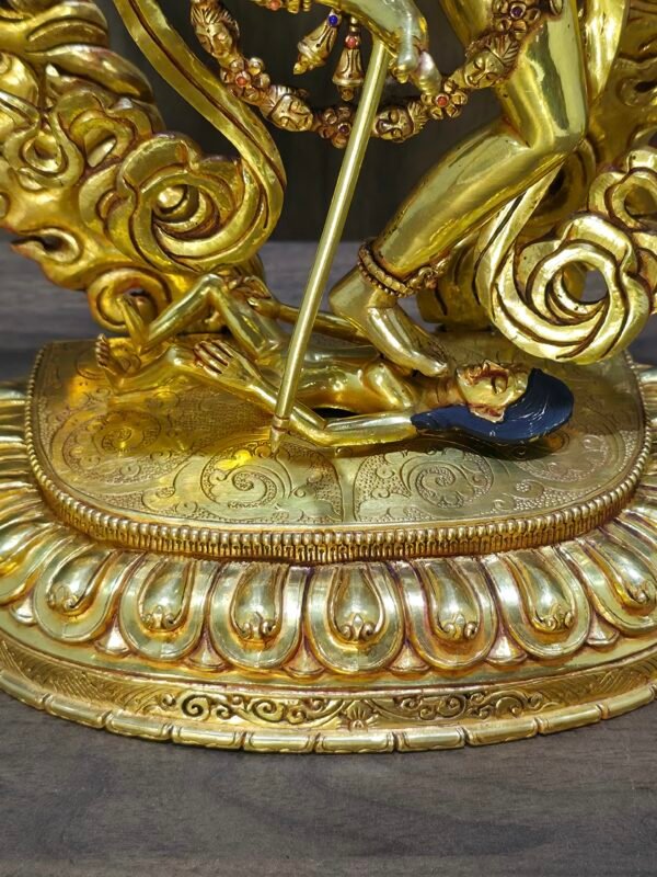 Close up of Dorje Phagmo Vajravarahi base showing the goddess stepping on a prostrate figure on an engraved lotus style pedestal.