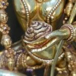 Close up of the Kapala skull cup held at the heart in Dorje Phagmo's left hand.