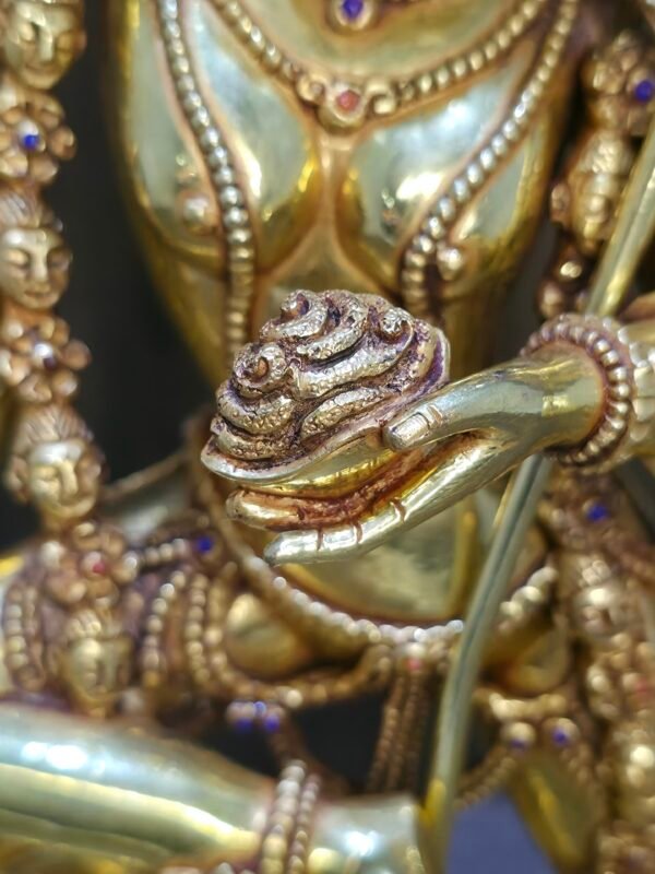 Close up of the Kapala skull cup held at the heart in Dorje Phagmo's left hand.