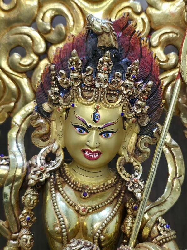 Close up of Dorje Phagmo hand-painted gold face and the defining sow's head on the right temple.