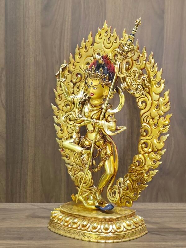 Right view of Dorje Phagmo Vajravarahi statue showing side profile, gold plated body, detailed halo scrollwork and staff.