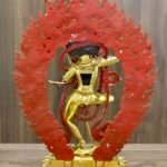 Back view of Dorje Phagmo Vajravarahi statue showing red painted reverse of the halo and rear figure details on the base.