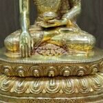 Detailed shot of the double lotus throne and base of the statue, featuring precise metalwork and a high-lustre gold finish.