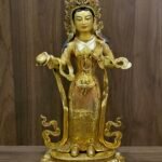 Full front view of Yeshe Tsogyal statue on lotus base holding a shallow ritual cup.