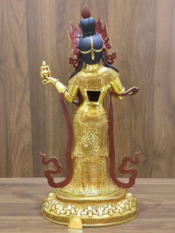 Rear view of Mandarava statue showing engraved back robes, open back cavity, and ritual vase in hand.