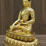 Right angled view of Shakyamuni Buddha statue with earth touching gesture on lotus throne.