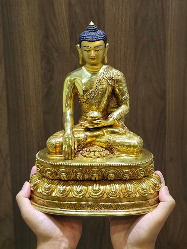 Scale view of Shakyamuni Buddha statue held in two hands showing size and proportions.