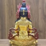 Rear view of Amitayus Buddha showing dark painted hair, red-backed crown and scarf ornaments, and scrolling patterns on the garments and base.
