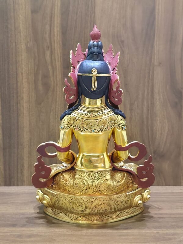 Rear view of Amitayus Buddha showing dark painted hair, red-backed crown and scarf ornaments, and scrolling patterns on the garments and base.