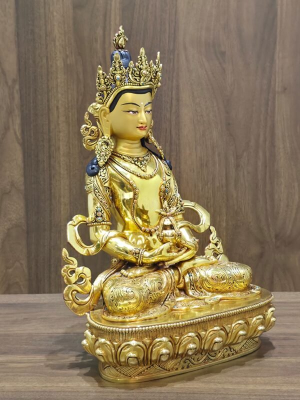 Right-facing angled view of Amitayus Buddha showing the gold plated copper body, ornate crown and sculpted lotus pedestal.
