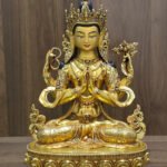 Alternate frontal view of four-armed Chenrezig statue with hands joined at the heart, prayer beads and a lotus.