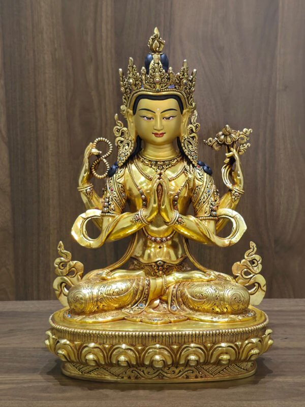 Alternate frontal view of four-armed Chenrezig statue with hands joined at the heart, prayer beads and a lotus.